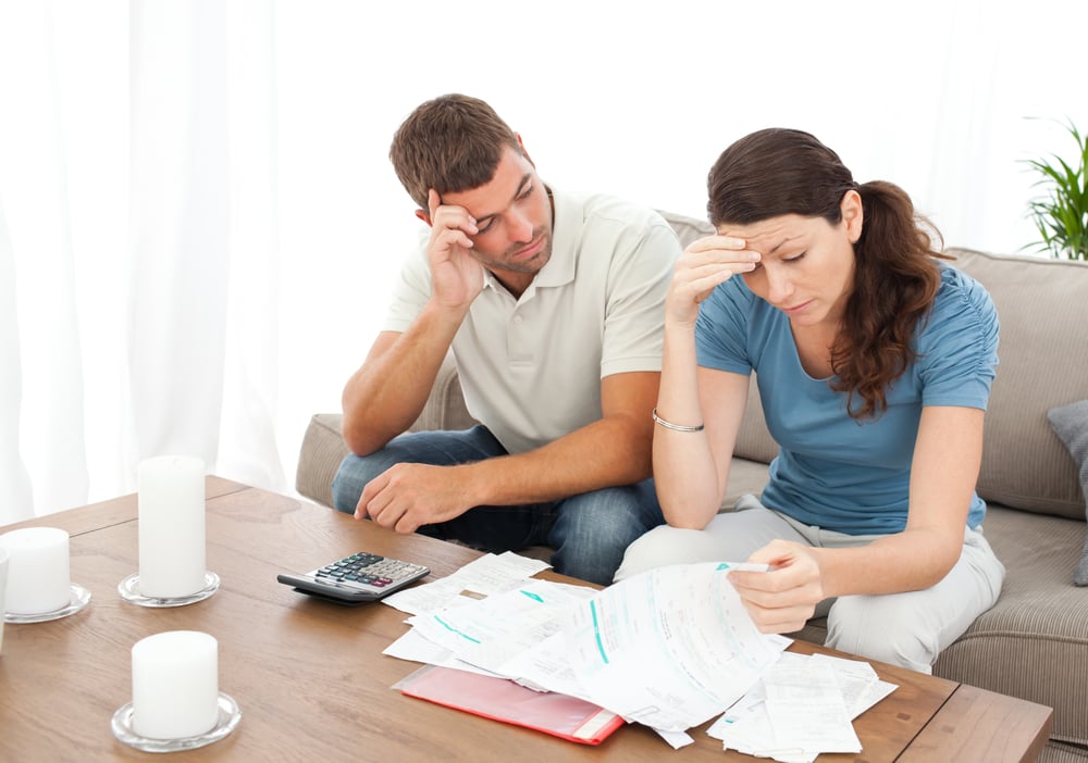 Worried couple doing their accounts in the living room at home-1